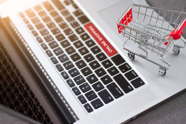 Shopping cart trolley on laptop with text online shopping - Photo, Image