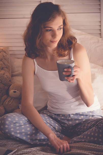 Beautiful woman drinking a coffee in her bed. Lifestyle concept. - Fotó, kép