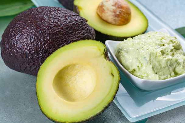 Avocado skin & hair care home spa, ripe avocados and bowl with face mask - Photo, Image