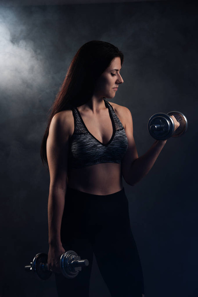 Active young woman workout with dumbbells  - Fotoğraf, Görsel