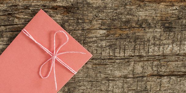 envelope tied with ribbon on wooden background - Photo, Image