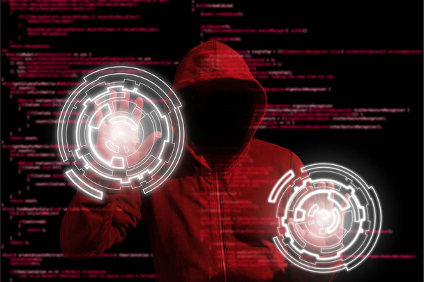 Pirata informático con capucha roja infiltrándose en un ordenador mediante controles circulares
 - Foto, Imagen