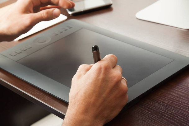 Graphic designer draws on a tablet - Photo, Image