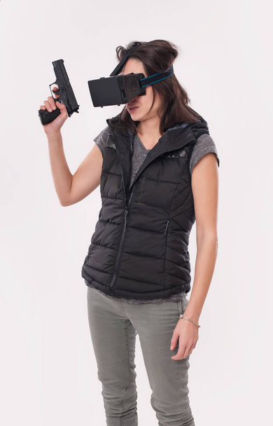 Woman play VR shooter game with vr glasses and gun - Photo, image