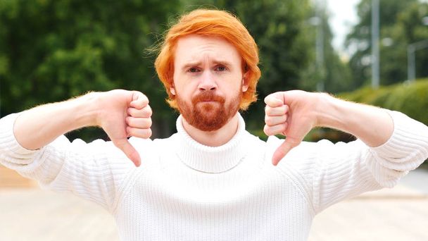 Thumbs Down with Both Hands by Man with Red Hairs, Outdoor - Photo, Image