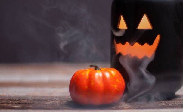 Halloween pumpkin with smoke and light in the dark night - Фото, изображение