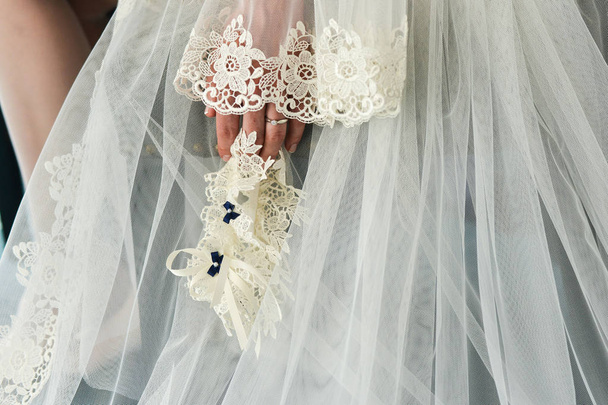 Garter on the leg of a bride, Wedding day moments - Photo, Image