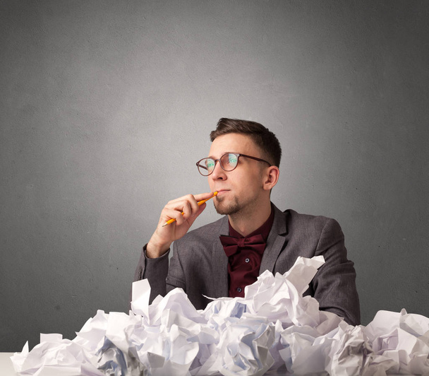 Businessman behind crumpled paper - Фото, изображение