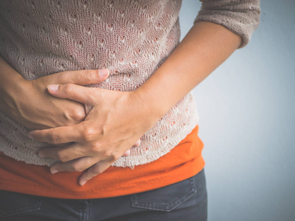 Young woman having painful  stomachache. Chronic gastritis. Abdomen bloating concept. - Foto, Bild