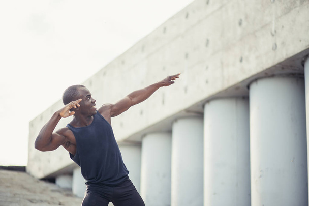 young black runner makes gesture of a winner - Foto, Imagen