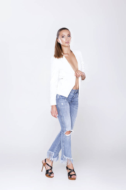 beautiful sexy woman in white jacket and jeans - Foto, afbeelding