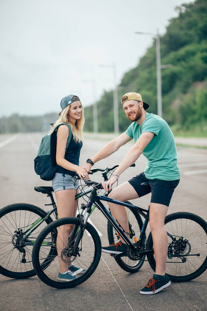 Young hipster couple holding hands standing on road - Photo, Image