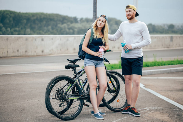 Young hipster couple holding hands standing on road - Valokuva, kuva