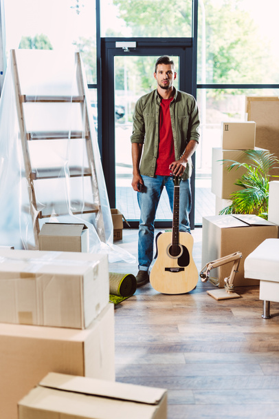 man with guitar in new house - Photo, Image