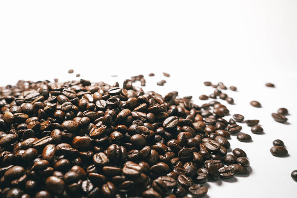 Grains of coffee on a white table - Фото, зображення