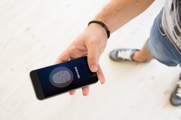 male hands fingerprint unlock smartphone  - Foto, imagen