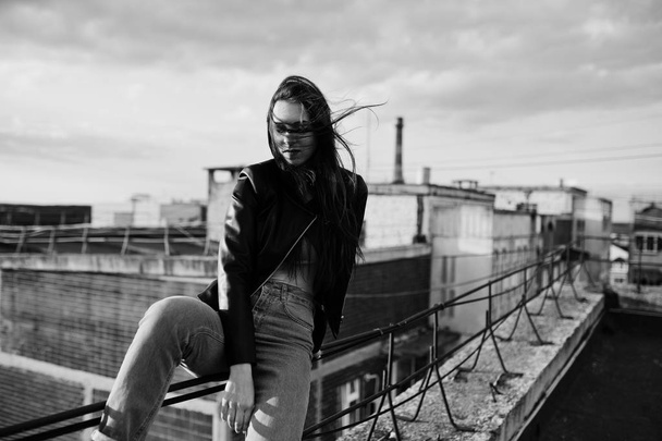 Portrait of a gorgeous young woman in black leather jacket, jean - Fotó, kép