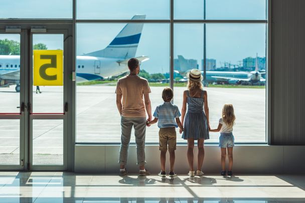 family looking out window in airport - Foto, immagini