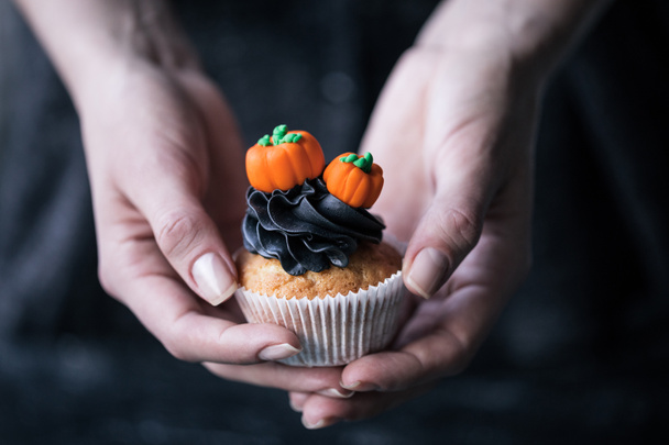 person holding halloween cupcake - 写真・画像