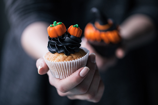 halloween cupcake in hand - Photo, Image