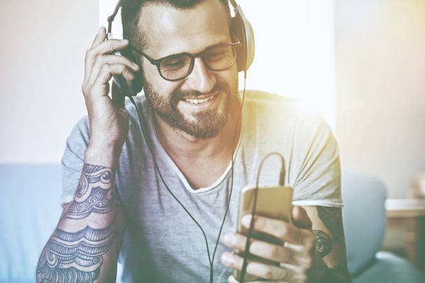 smiling man listening to music  - Photo, image
