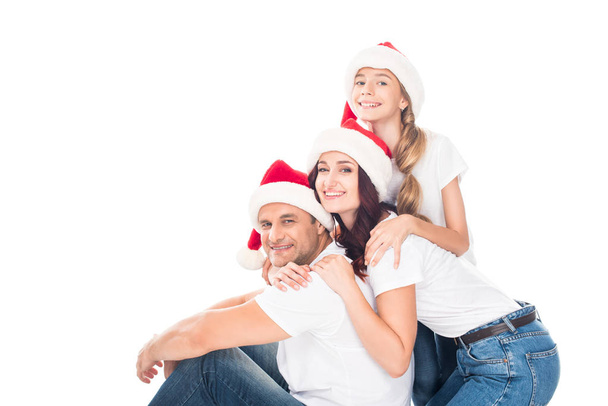 embracing family in Santa hats - Foto, imagen