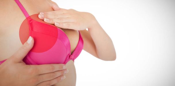 woman in pink bra examining breast  - 写真・画像