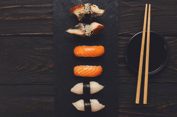 Set of sushi on black wood background, top view - Photo, Image