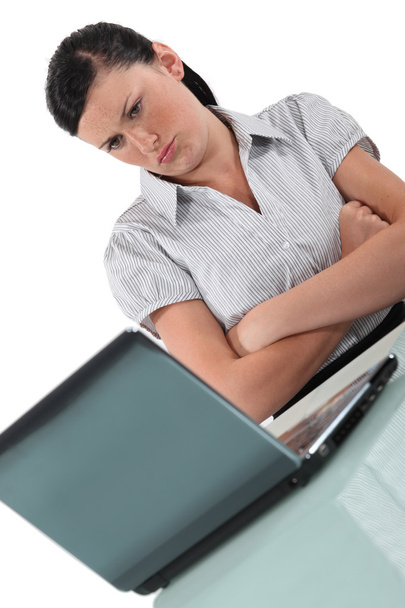 Woman pouting in front of her computer - Foto, immagini