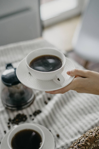 Mug with coffee in the hand of woman - Valokuva, kuva