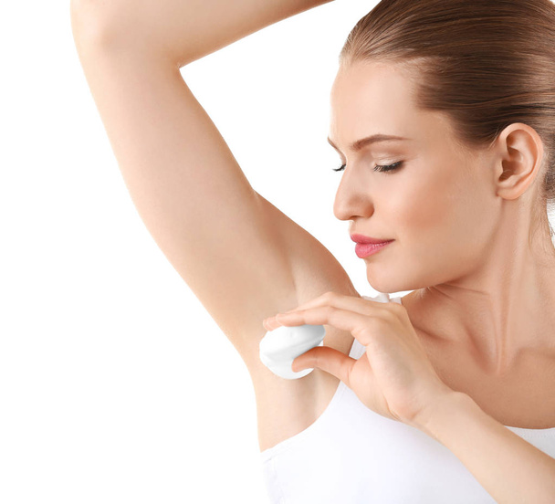 Beautiful young woman with deodorant  - 写真・画像