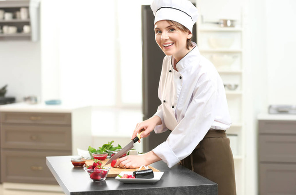 Female chef cooking  - Foto, afbeelding