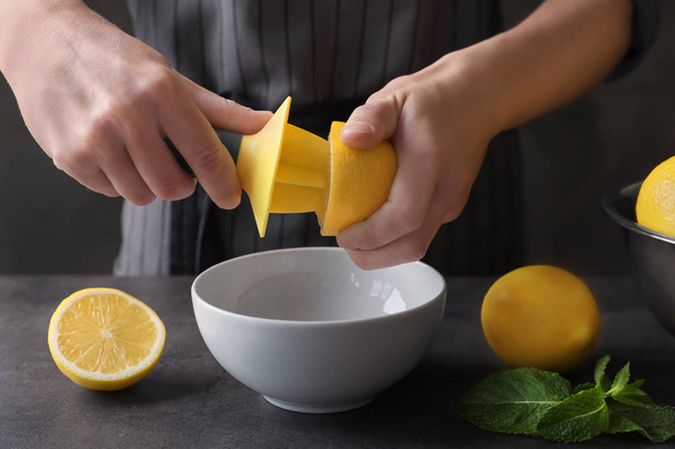 Man extracting lemon juice  - Fotó, kép