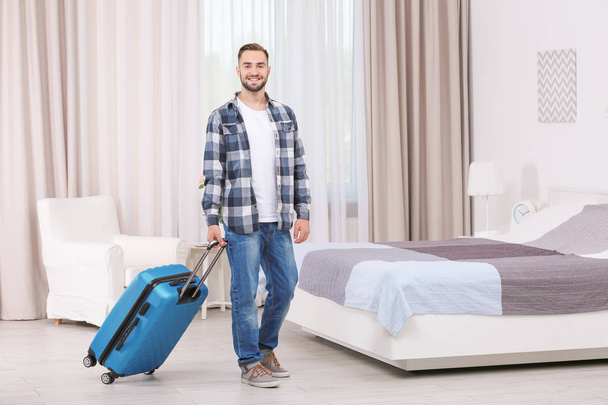 Young man with luggage  - Foto, Bild