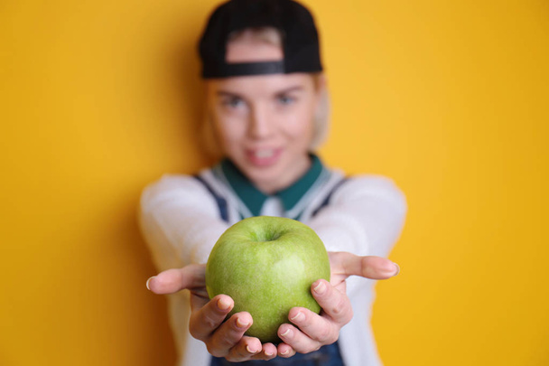 Young woman holding green apple   - Φωτογραφία, εικόνα
