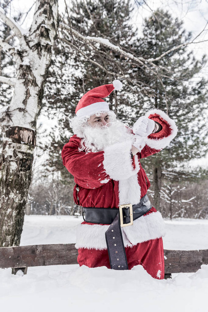 Santa Claus looking on watch - Φωτογραφία, εικόνα