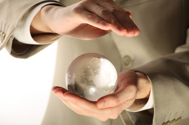 üzletember holding mini globe - Fotó, kép