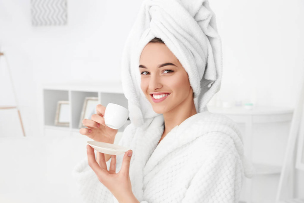woman after shower in bathrobe with cup of coffee - Foto, Imagen