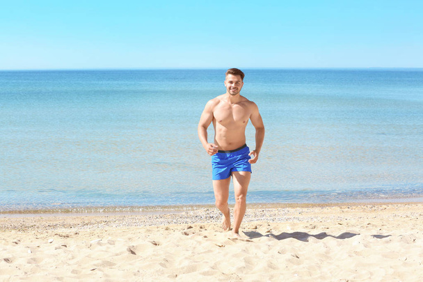 young man on beach - Zdjęcie, obraz