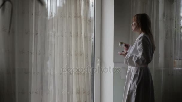 Pretty woman looking out the window. - Video, Çekim