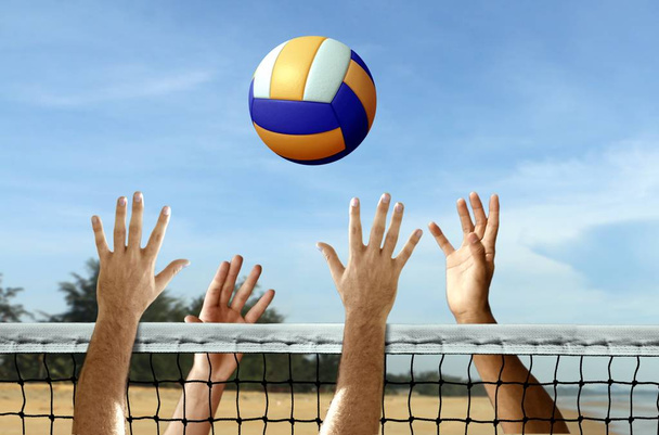 Volleyball at the beach under blue sky - Foto, afbeelding