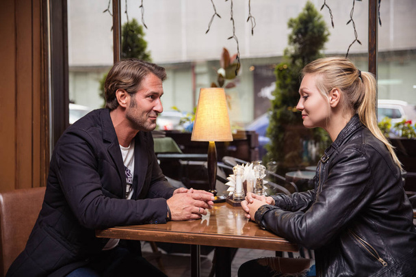 Portrait of beautiful couple in love at a coffee shop - Фото, зображення