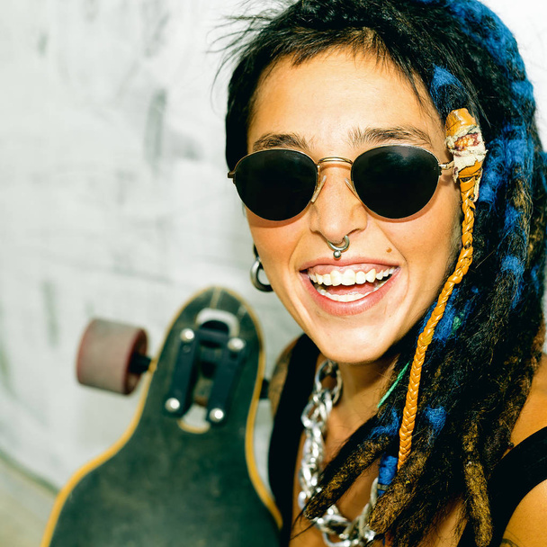 Happy Girl Skater with Dreadlocks. Street style - Foto, Imagen