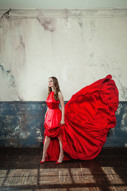 Sexy Model Woman in Red Blowing Dress. Beautiful Fashion Model - Fotó, kép