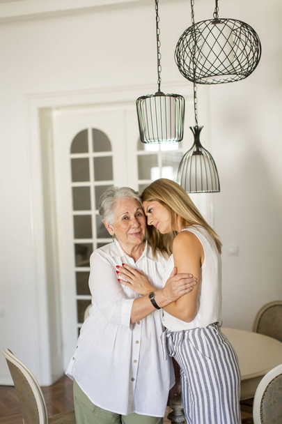 Granddaughter hugging grandmother - Photo, Image