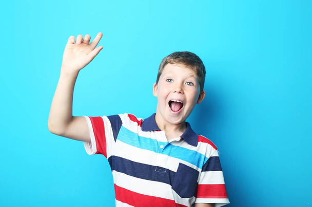 Portrait of young boy on blue background - Foto, Imagen