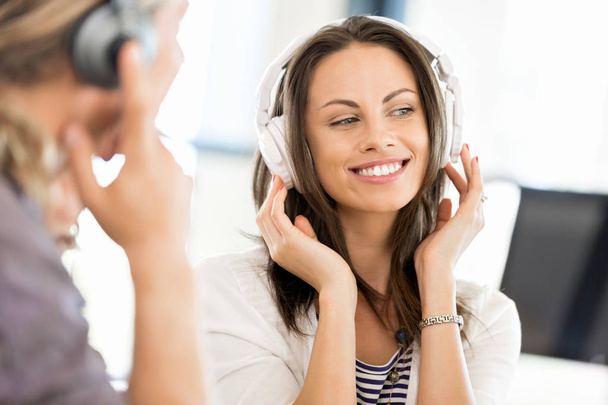 Young woman with headphones indoors - Фото, изображение