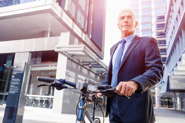Successful businessman with bicycle - Zdjęcie, obraz