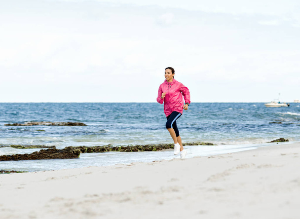 Young Woman Jogging On The Beach - Zdjęcie, obraz