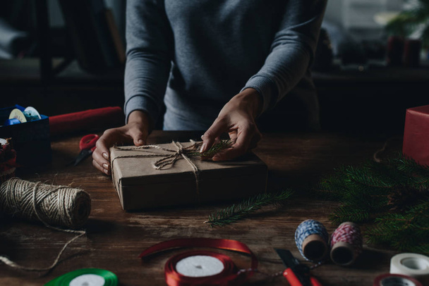 woman decorating christmas gift - Foto, afbeelding